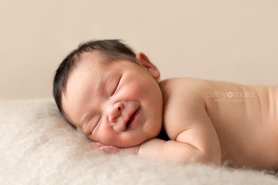 Precious Asian Newborn Baby Girl smiling in the picture taken by Los Angeles (Alhambra) Newborn Photographer, Cathy Murai Photography 