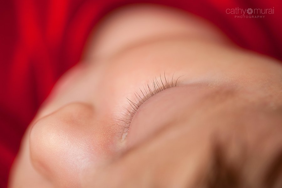 Newborn Christmas Portrait session with a 1 month old baby girl with a beautiful long eye lashes