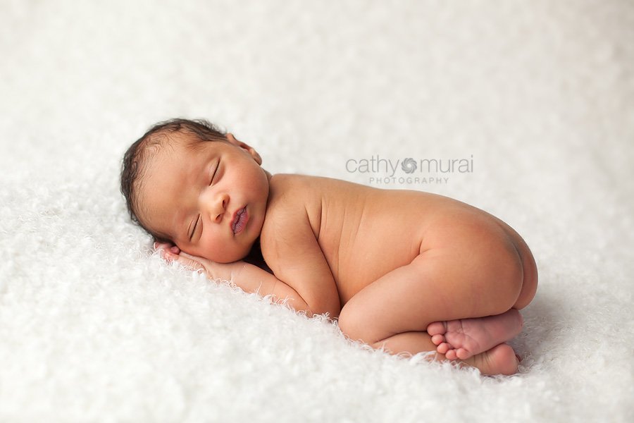 African American baby boy sleeping and posing peacefully on the white blanket - taken by  Alhambra Newborn and Baby photographer, Cathy Murai Photography, Los Angeles Newborn and Baby Photographer