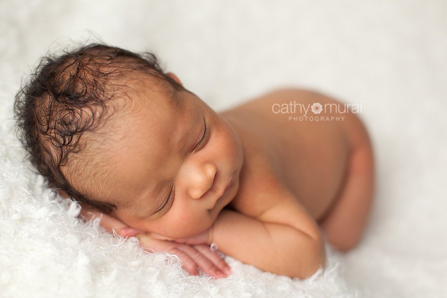 African American baby boy with curly hair sleeping and posing peacefully on the white blanket - taken by  Alhambra Newborn and Baby photographer, Cathy Murai Photography, Los Angeles Newborn and Baby Photographer