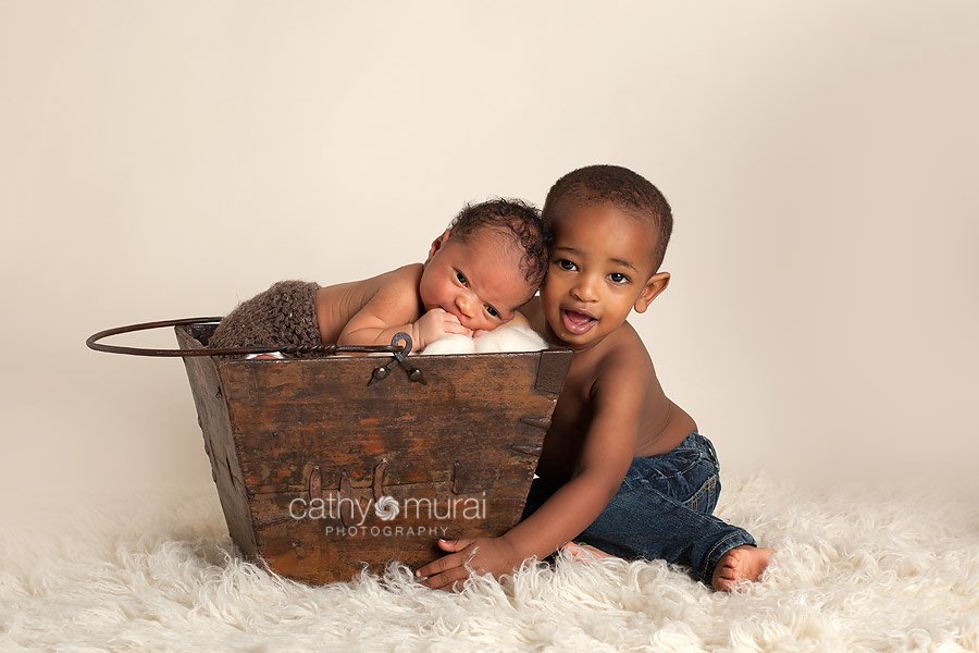 Brotherly love, siblings portrait, sibling shot, siblings photography - African American baby boy sleeping and posing with his older brother - taken by  Alhambra Newborn and Baby photographer, Cathy Murai Photography, Los Angeles Newborn and Baby Photographer