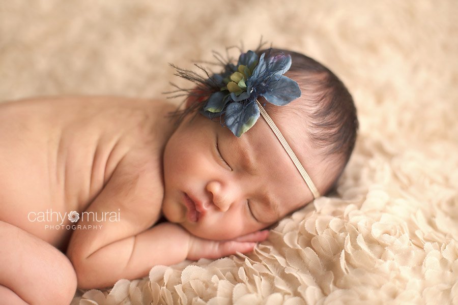 Newborn baby girl, blue headband, posing while sleeping, picture, image, portrait - captured by Los Angeles Newborn Photographer, Cathy Murai Photography