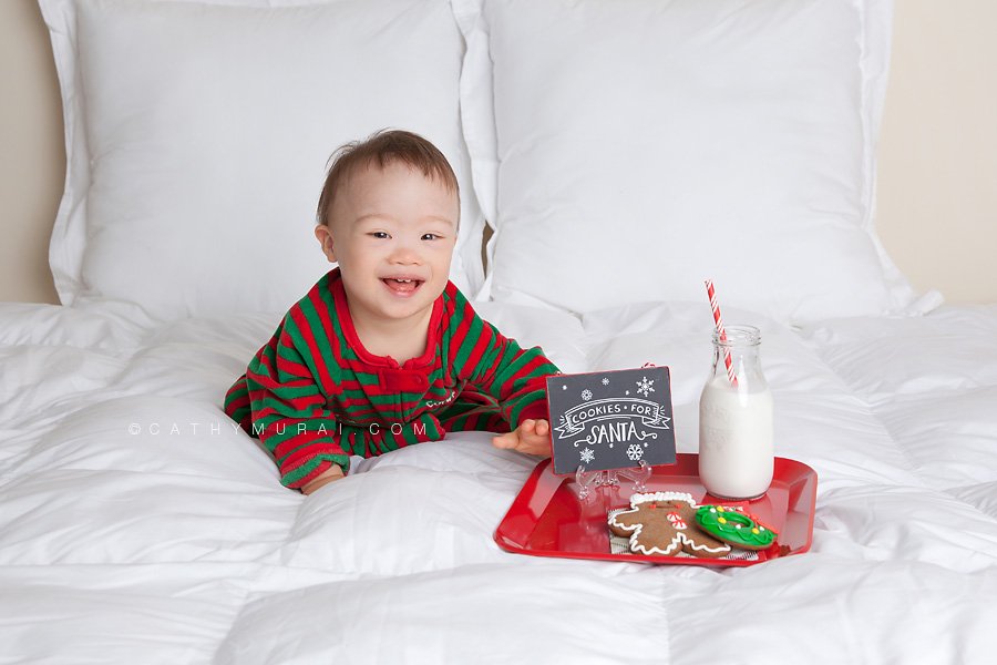 A handsome boy wearing Christmas pajama smling while waiting for santa clause with cookies and milk, Cathy-Murai-Photography- Alhambra-South Pasadena-Pasadena-San Marino-San Gabriel Valley-Los Angeles-studio photography-Professional Christmas Photographer-Professional Christmas Photography-Christmas toddler photography-Christmas toddler pictures-Christmas toddler photography props-Christmas toddler photography ideas- toddler Christmas portraits- toddler Christmas photography- toddler Christmas Photography