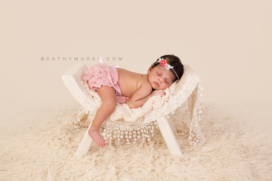 Indian newborn wearing pink headband and pink diaper cover sleeping on ivory curve bench on cream flokati rug, indian newborn baby, indian newborn baby girl, best newborn photographer,Los Angeles newborn baby photographer,Los Angeles newborn baby photography,famous baby photographer,famous newborn photographer,los angeles newborn photographer,los angeles newborn photography,los angeles newborn photographer,los angeles newborn photography,los angeles twin newborn photographer,los angeles twin newborn photography,newborn photo shoot los angeles,newborn photographer los angeles,newborn photographer alhambra,newborn photography los angeles, premier newborn photographer, Pasadena newborn baby photographer,Pasadena newborn photographer,San Gabriel Valley newborn photography,San Gabriel Valley newborn photographer,Alhambra newborn photography,top newborn photographer, Las Tunas newborn photography,Las Tunas newborn photographer, Cathy Murai Photography, newborn and sibling photographer, newborn and sibling photography, newborn and sibling pictures, newborn and sibling photos newborn and sibling pictures