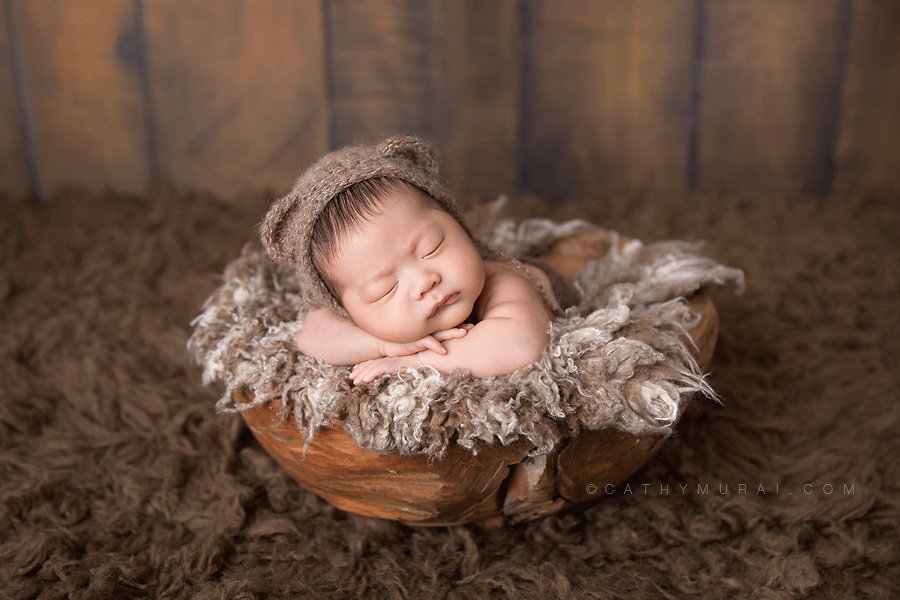 Asian newborn baby wearing teddy bear hat, sleeping and posing on the wooden bowl, covered with brown and cream furs, newborn baby boy photography, best newborn photographer,Los Angeles newborn baby photographer,Los Angeles newborn baby photography,famous baby photographer,famous newborn photographer,los angeles newborn photographer,los angeles newborn photography,los angeles newborn photographer,los angeles newborn photography,los angeles twin newborn photographer,los angeles twin newborn photography,newborn photo shoot los angeles,newborn photographer los angeles,newborn photographer alhambra,newborn photography los angeles, premier newborn photographer, Pasadena newborn baby photographer,Pasadena newborn photographer,San Gabriel Valley newborn photography,San Gabriel Valley newborn photographer,Alhambra newborn photography,top newborn photographer, Las Tunas newborn photography,Las Tunas newborn photographer, Cathy Murai Photography, newborn and sibling photographer, newborn and sibling photography, newborn and sibling pictures, newborn and sibling photos newborn and sibling pictures, Mother and newborn photography, newborn posing