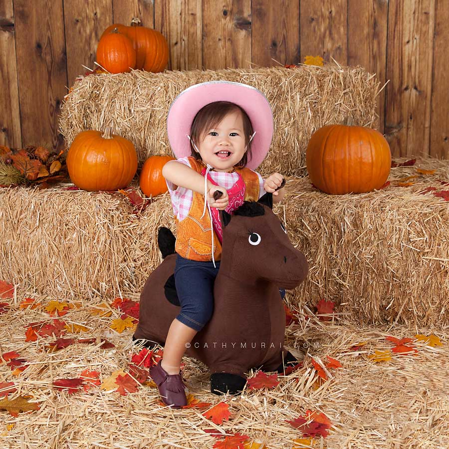 cow girl baby riding on a horse, Happy Halloween, Los Angeles Halloween Photographer, Halloween Mini Session, Hay and pumpkins, fall leaves