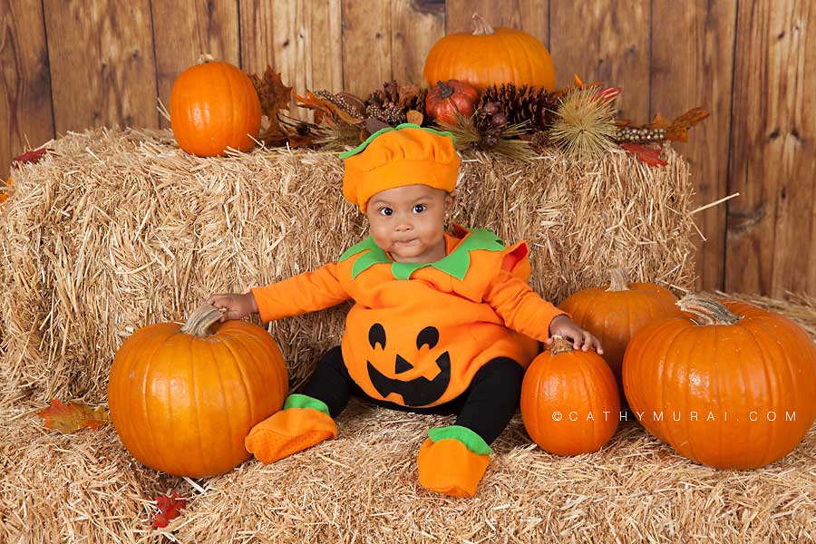 cute toddler in a pumpkin costume, Happy Halloween, Los Angeles Halloween Photographer, Halloween Mini Session, Hay and pumpkins, fall leaves