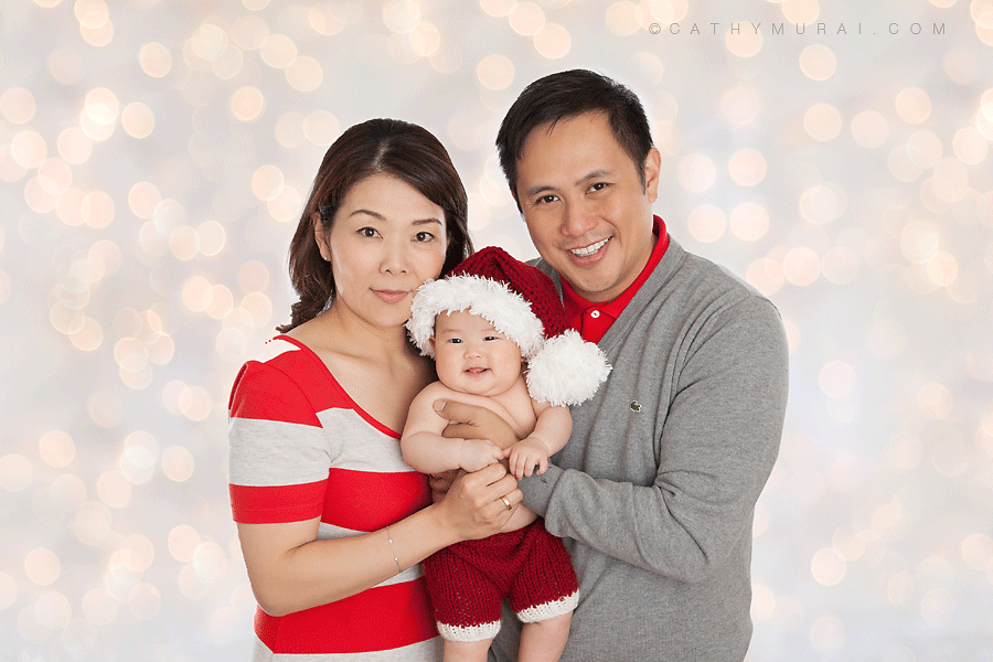 3 months old baby wearing santa outfit smiling in the family portrait taken in front of christmas lights, Christmas Family Portrait Session, Los Angeles Christmas Family Portrait Session, Alhambra Christmas Family Portrait Session, Pasadena Christmas Family Portrait Session, South Pasadena Christmas Family Portrait Session, Las Tunas Christmas Family Portrait Session, Rosemead Christmas Family Portrait Session, San Marino Christmas Family Portrait, El Monte Christmas Family Portrait Session, South El Monte Christmas Family Portrait Session, San Gabriel Valley Christmas Family Portrait Session, Monrovia Christmas Family Portrait Session, Glendale Christmas Family Portrait Session, North Hollywood Christmas Family Portrait Session, Los Angeles Christmas Family photographer Family Christmas Family photographer, Los Angeles Christmas Family Family photography, famous Family photographer, famous Christmas Family photographer, los Angeles best Christmas Family photographer, Los Angeles Christmas Family photography, los Angeles Christmas Family photographer, los Angeles, Christmas Family photography, Alhambra, Christmas Family photography, Pasadena Christmas Family Family photographer, Pasadena Christmas Family photographer, San Gabriel Valley Christmas Family photography, San Gabriel Valley Christmas Family photographer, Alhambra Christmas Family photography, Las Tunas Christmas Family photography, Las Tunas Christmas Family photographer