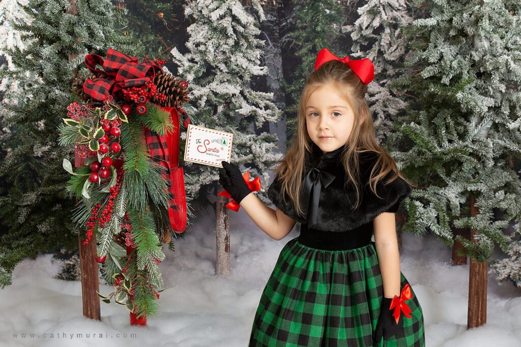 Holiday mini photo sessions near me Cathy Murai Photography captured this adorable girl sending out a letter for Santa during holiday mini sessions in Orange County. 2020 Christmas mini photo session in Irvine, CA