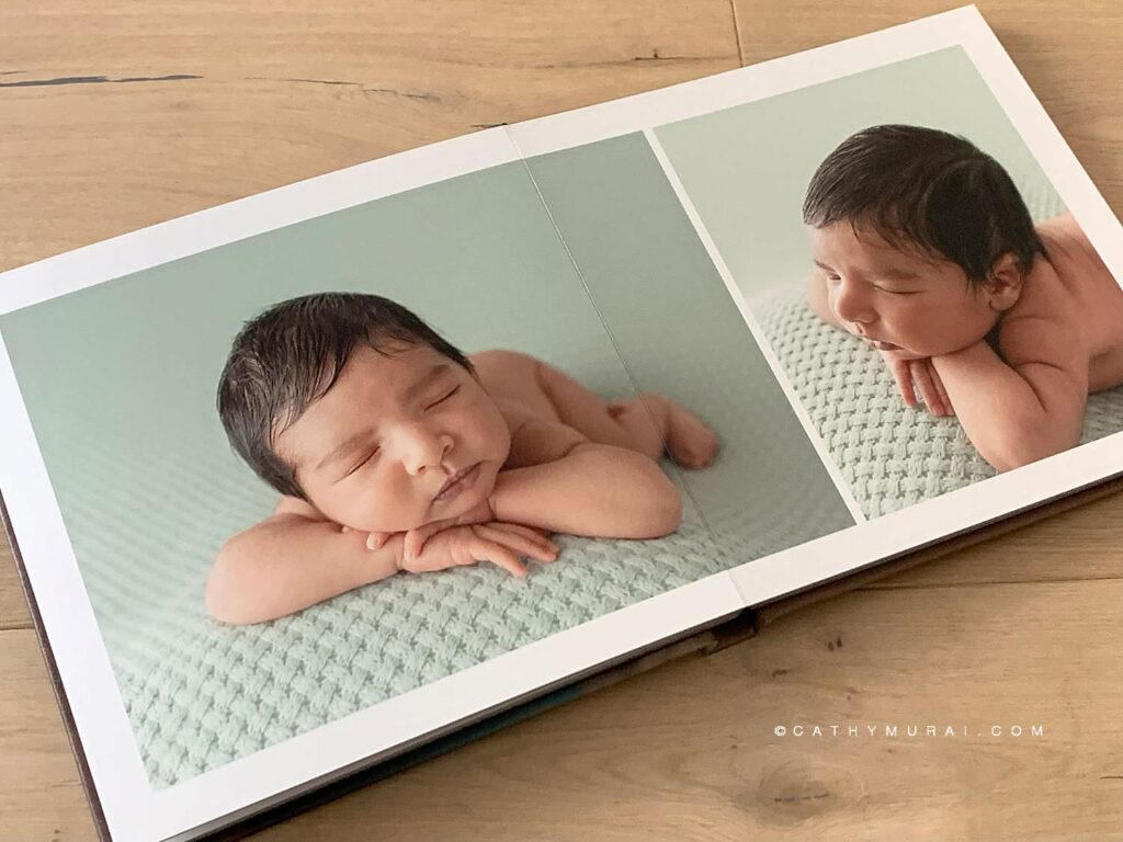 Photo album page spread displaying photos of newborn baby boy sleeping on a mint-colored blanket, taken during his newborn photo session with Cathy Murai Photography, orange county newborn photographer, in her studio in Irvine